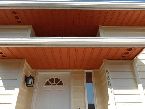 picture of freshly painted gutters in bright orange